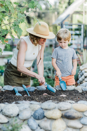 Adult and child gardening while using Rutabaga Garden Tools. Tools with the perfect handle for both big hands and small.
